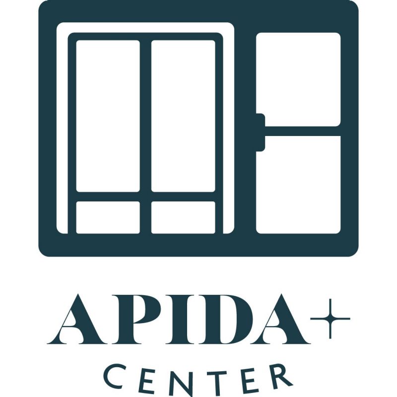 APIDA + Center Logo APIDA + Center Logo Green Glass Wall and Door Entrance with Text Underneath